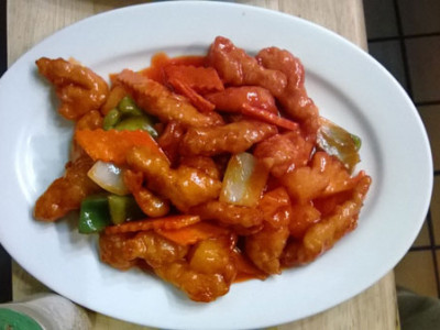 Sweet and Sour Chicken: slices of breast stir fried with green peppers, pineapple, and white onions in a red sweet and sour sauce.
